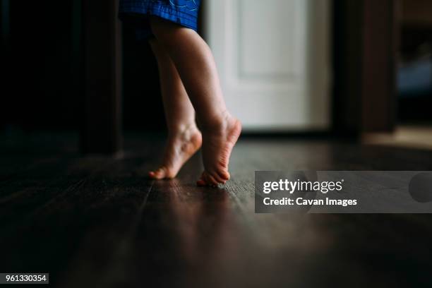 low section of boy tiptoeing - tiptoe stock pictures, royalty-free photos & images