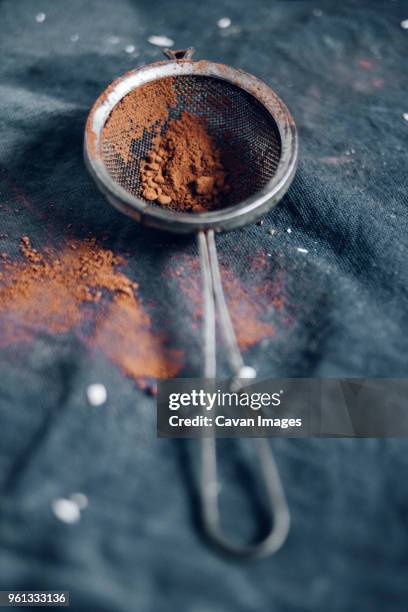 close-up of cocoa powder in flour sifter - flour sifter stock pictures, royalty-free photos & images