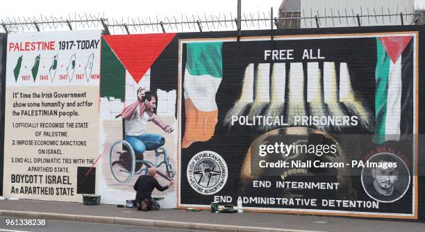 Belfast artist Marty Lyons paints a mural on the Falls Road of Palestinian Fadi Abu Salah, who lost his legs in 2008 in an airstrike and was killed...