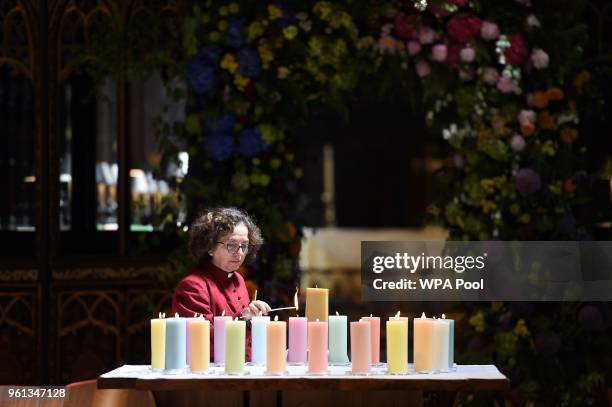 Member of the clergy lights candles for the victims of Mancester Arena attack, ahead of The Manchester Arena National Service of Commemoration at...