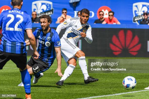 Los Angeles Galaxy midfielder Jonathan dos Santos kicks the ball away from Montreal Impact midfielder Marco Donadel during the LA Galaxy versus the...