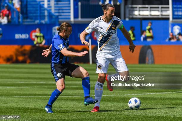 Montreal Impact midfielder Samuel Piette tries to stop Los Angeles Galaxy forward Zlatan Ibrahimovic from gaining control of the ball during the LA...