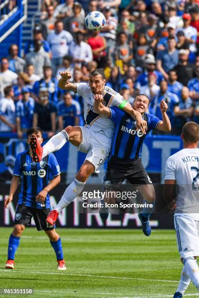 Los Angeles Galaxy forward Zlatan Ibrahimovic and Montreal Impact midfielder Samuel Piette jumping in the air for the ball during the LA Galaxy...