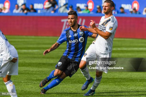 Montreal Impact midfielder Saphir Taider and Los Angeles Galaxy midfielder Perry Kitchen track the ball during the LA Galaxy versus the Montreal...