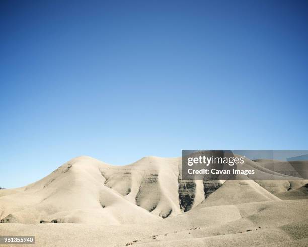 scenic view of desert against clear blue sky during sunny day - loam stock pictures, royalty-free photos & images