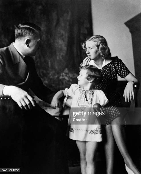 Eva Braun poses with Ursula "Uschi" Schneider, daughter of her best friend Herta Schneider, and her companion Adolf Hitler, Führer of the German...