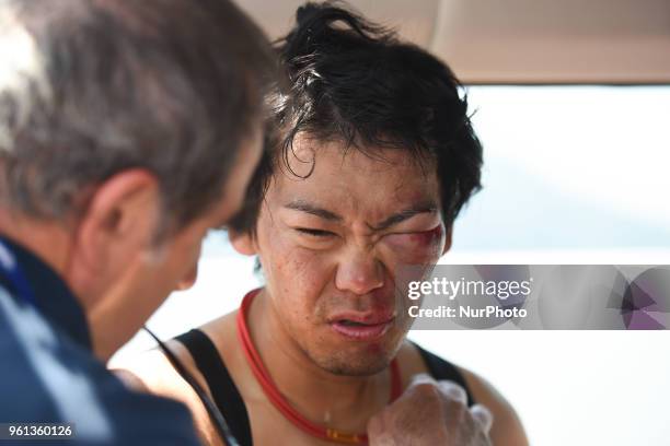 Japanese injured rider, Yukiya Arashiro from Bahrain - Merida Team, receives a medical help at the end of Inabe stage, 127.0km on Inabe circuit race,...