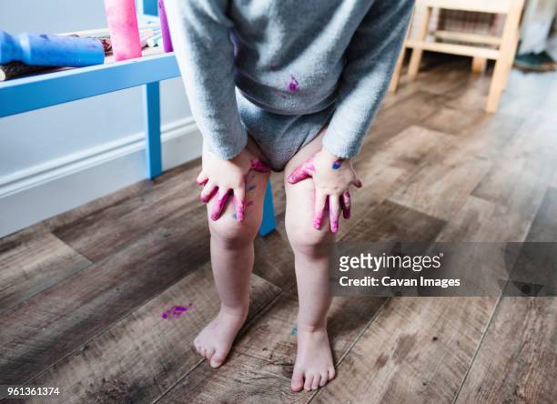 low section of girl standing with hands on knees - standing with hands on knees imagens e fotografias de stock