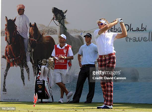 Ian Poulter of England plays his tee shot at the par 3, 7th hole watched by Martin Kaymer of Germany during the final round of The Abu Dhabi Golf...