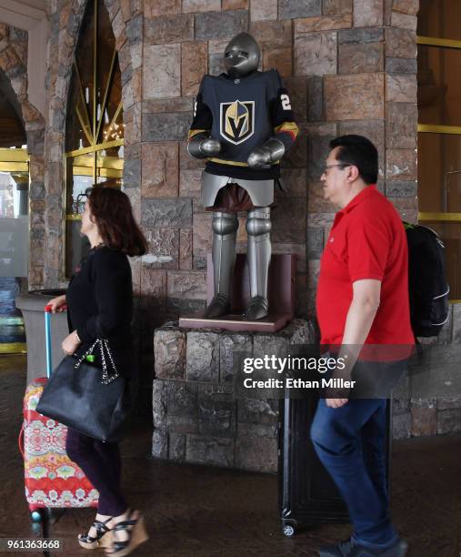 Guests walk by a knight at Excalibur Hotel & Casino wearing a jersey of goaltender Marc-Andre Fleury of the Vegas Golden Knights the day after the...