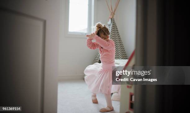 girl in ballet costume dancing at home seen through doorway - bedroom doorway stock pictures, royalty-free photos & images