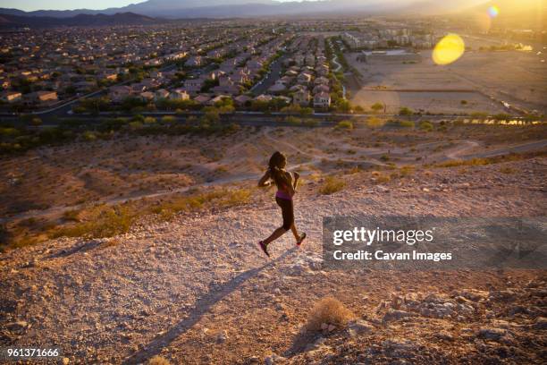 high angle view of jogger on hill by village during sunny day - las vegas village ストックフォトと画像