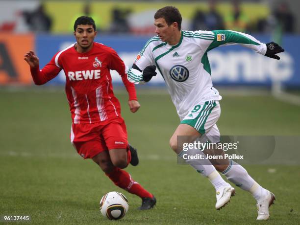 Edin Dzeko of Wolfsburg and Adil Chihi of Koeln compete for the ball during the Bundesliga match between VfL Wolfsburg and 1. FC Koeln at Volkswagen...