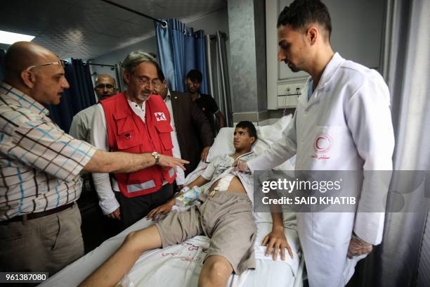 Francesco Rocca , the President of the International Federation of Red Cross and Red Crescent Societies, meets a Palestinian, receiving treatment for...