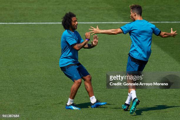 Cristiano Ronaldo of Real Madrid CF celebrates with teammate Marcelo during a training session held during the Real Madrid UEFA Open Media Day ahead...