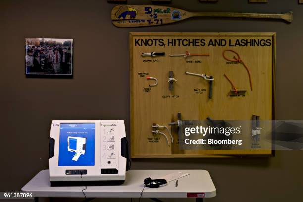 Voting machine for the visually impaired sits on a table near a boy scouts display at a polling station in Louisville, Kentucky, U.S., on Tuesday,...