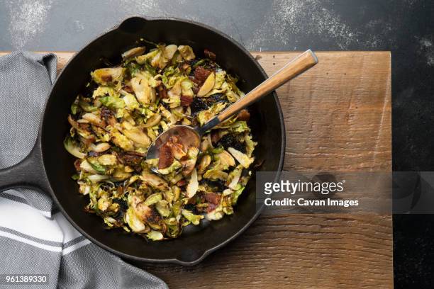 overhead view of brussels sprout in skillet - brussels sprout stock-fotos und bilder