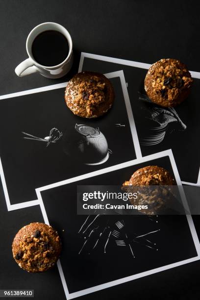 high angle view of muffins with coffee and photographs on table - raisin bran stock pictures, royalty-free photos & images