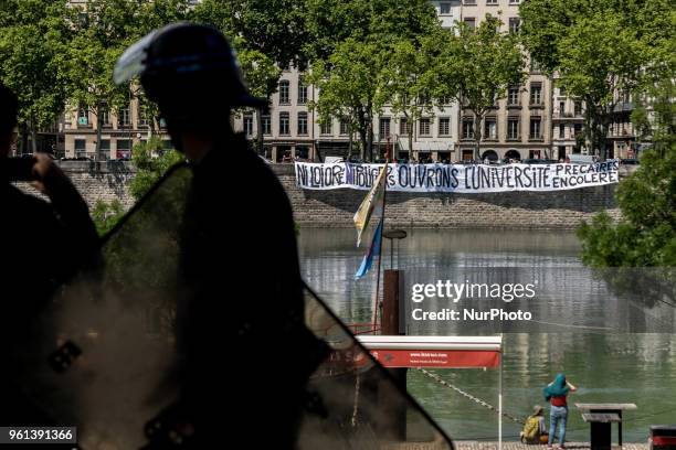 Protesters take part in a demonstration on May 22 in Lyon, central-eastern France, as part of a nationwide day of striking by French public sector...