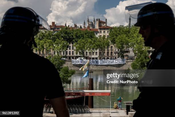 Protesters take part in a demonstration on May 22 in Lyon, central-eastern France, as part of a nationwide day of striking by French public sector...