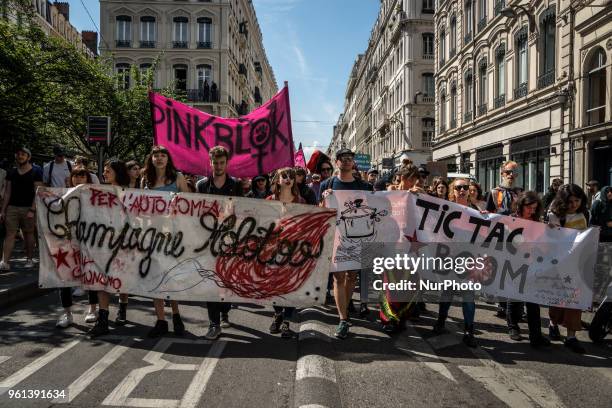 Protesters take part in a demonstration on May 22 in Lyon, central-eastern France, as part of a nationwide day of striking by French public sector...