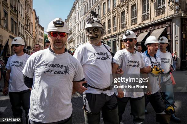Protesters take part in a demonstration on May 22 in Lyon, central-eastern France, as part of a nationwide day of striking by French public sector...