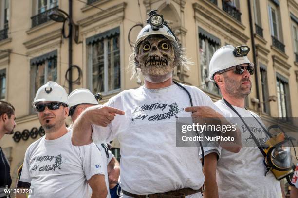 Protesters take part in a demonstration on May 22 in Lyon, central-eastern France, as part of a nationwide day of striking by French public sector...