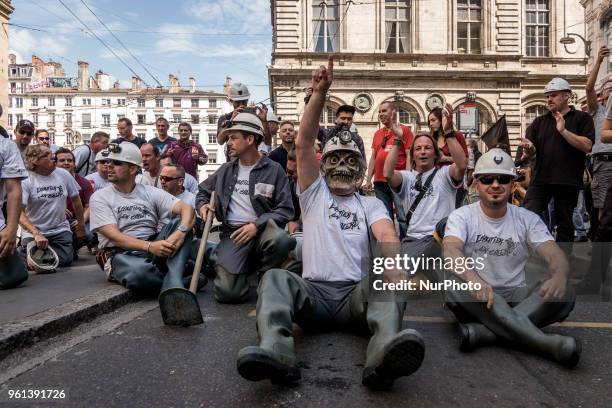 Protesters take part in a demonstration on May 22 in Lyon, central-eastern France, as part of a nationwide day of striking by French public sector...