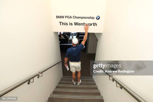 Liverpool supporter, Jamie Donaldson touches the 'This is Wentworth' sign in the players lounge, in relation to the 'This is Anfield' sign during...