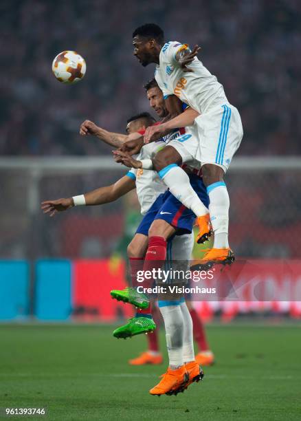Andre Zambo Anguissa and Dimitri Payet of Olympique de Marseille jump for a header with Gabi of Club Atletico de Madrid during the UEFA Europa League...