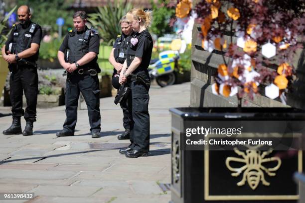 Police officers observe a minutes silence next a Tree of Hope during The Manchester Arena National Service of Commemoration at Manchester Cathedral...