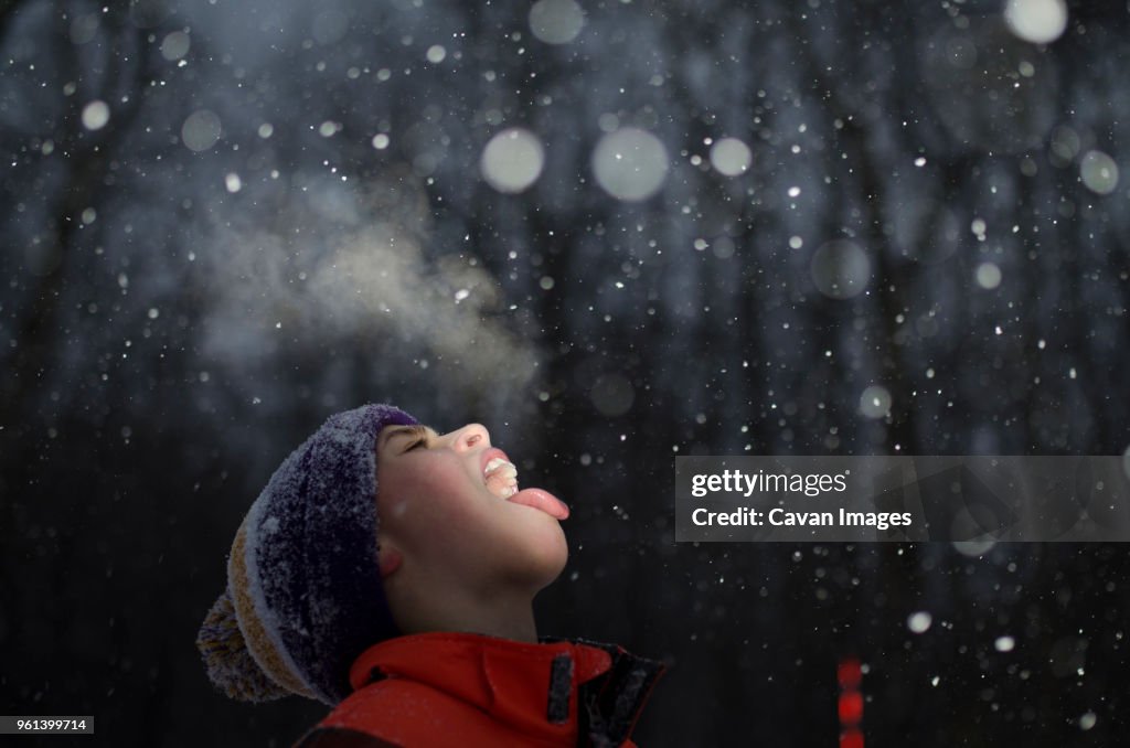 Boy with mouth open during snowing