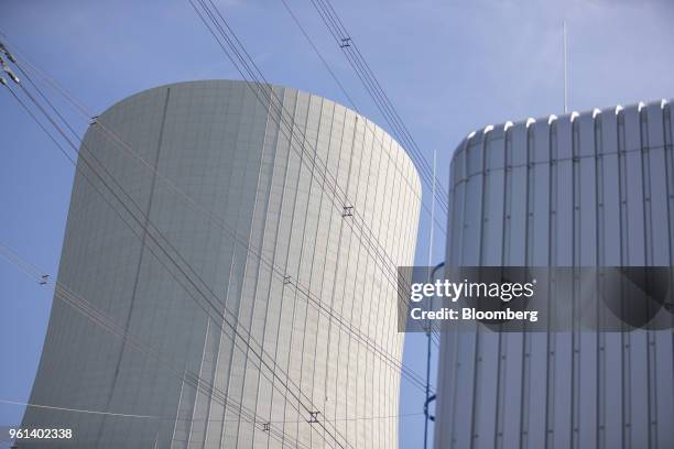 Power lines run beside a cooling tower at the coal powered power plant operated by RWE AG in Lingen, Germany, on Tuesday, May 22, 2018. RWE is...