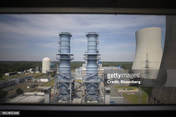 Gas turbine exhaust pipes stand beside cooling towers at the coal powered power plant operated by RWE AG in Lingen, Germany, on Tuesday, May 22,...