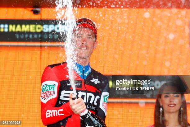 Australia's rider of team BMC Rohan Dennis celebrates on the podium after winning the 16th stage, a time trial between Trento and Rovereto, during...