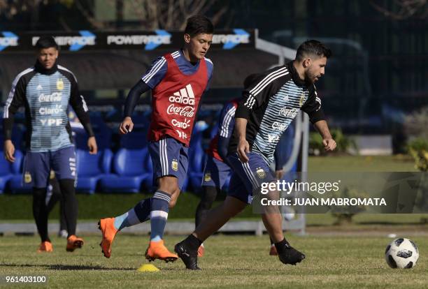 Argentina's forward Sergio Aguero passes the ball next to a sparring , during a training session in Ezeiza, Buenos Aires on May 22, 2018. - The...