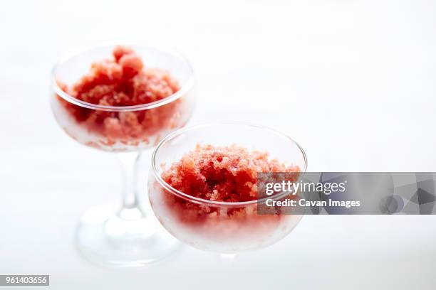 close-up of hibiscus watermelon granita in coupe glasses over white background - coupe dessert stock pictures, royalty-free photos & images