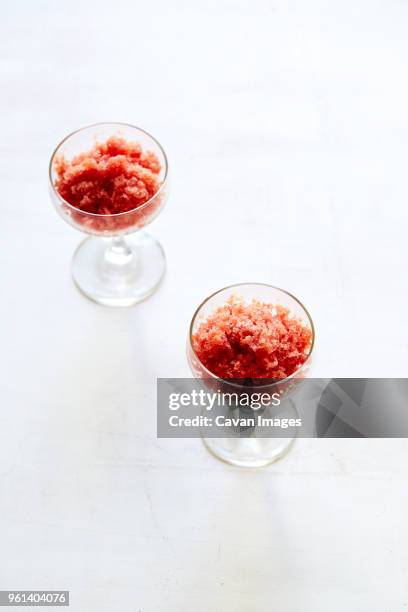 high angle view of hibiscus watermelon granita in coupe glasses over white background - coupe dessert stock pictures, royalty-free photos & images