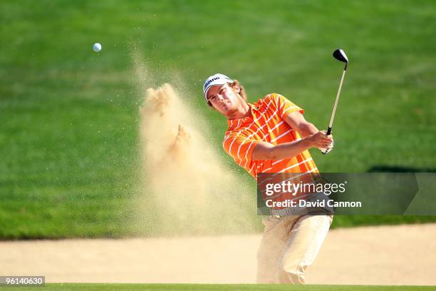 Chris Wood of England plays his third shot at the par 5, 8th hole during the final round of The Abu Dhabi Golf Championship at Abu Dhabi Golf Club on...