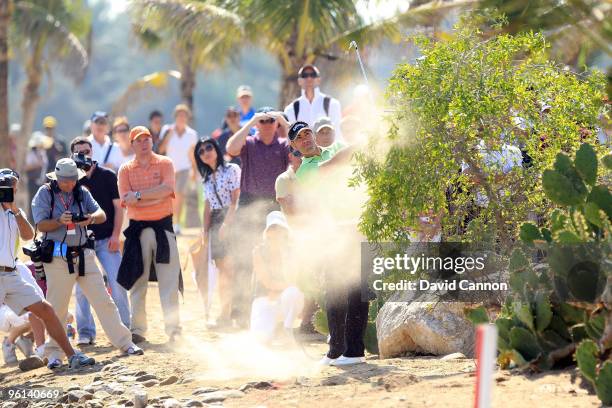 Alvaro Quiros of Spain plays his third shot at the par 4, 9th hole during the final round of The Abu Dhabi Golf Championship at Abu Dhabi Golf Club...