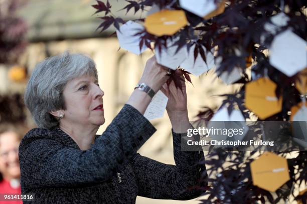 British Prime Minister Theresa May places a message on a Tree of Hope after The Manchester Arena National Service of Commemoration at Manchester...