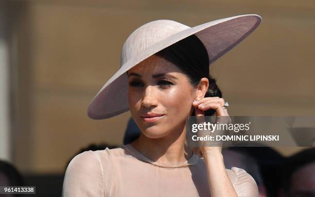 Britain's Meghan, Duchess of Sussex, attends the Prince of Wales's 70th Birthday Garden Party at Buckingham Palace in London on May 22, 2018. - The...