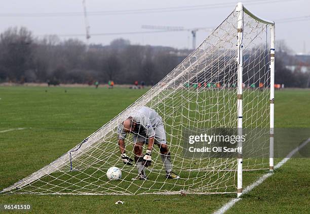 Sunday League goalkeeper retrieves the ball from the back of his net on the Hackney Marshes pitches on January 24, 2010 in London, England. Hackney...