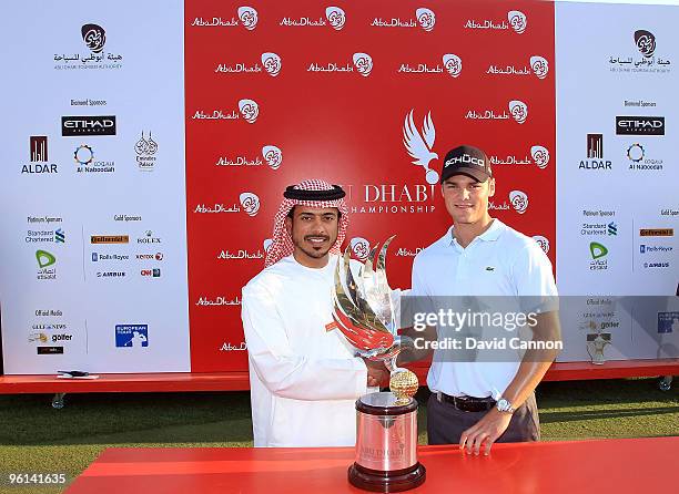 Martin Kaymer of Germany is presented with the trophy by Sheikh Sultan Bin Tahnoon Al Nahyan the Chairman of the Abu Dhabi Tourism Authority after...