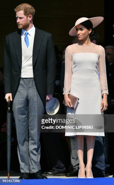 Britain's Prince Harry, Duke of Sussex , and his new wife, Britain's Meghan, Duchess of Sussex, attend the Prince of Wales's 70th Birthday Garden...