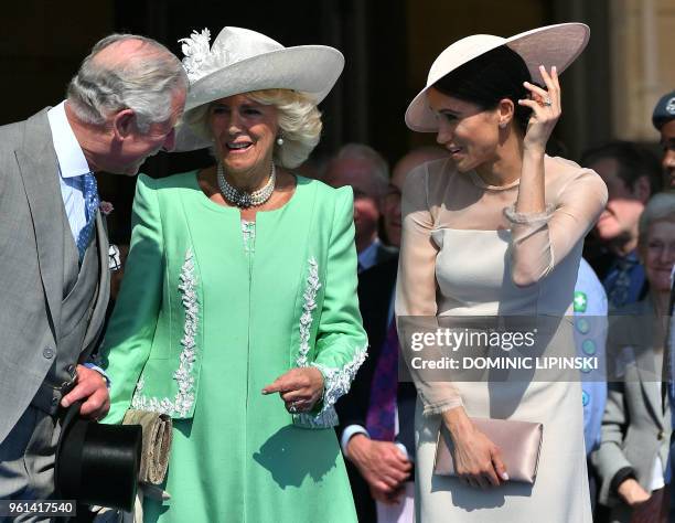 Britain's Prince Charles, Prince of Wales and his wife Britain's Camilla, Duchess of Cornwall , talk with Britain's Meghan, Duchess of Sussex, as her...