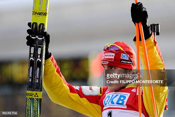Second placed Arnd Peiffer of Germany celebrates on the podium after the 12,5 km pursuit event of the Biathlon World Cup in Anterselva on January 24,...