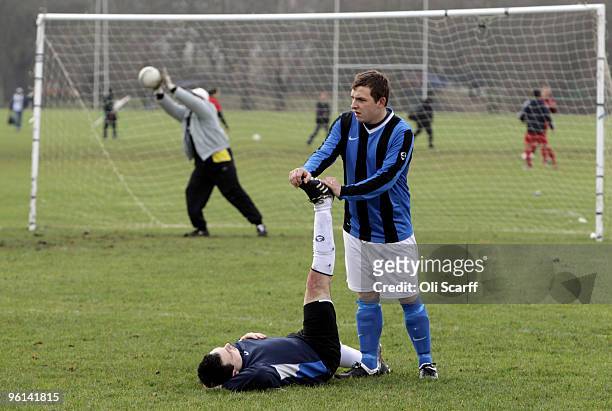 Sunday League footballer performs a leg stretch prior to playing on the Hackney Marshes on January 24, 2010 in London, England. Hackney Marshes is...