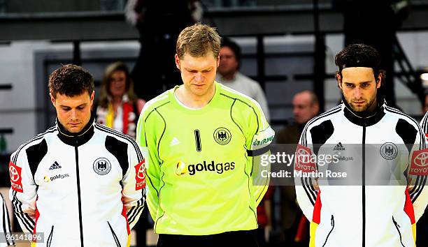 Michael Kraus and Johannes Bitter of Germany seen during a moment of silence prior to the Men's Handball European main round Group II match between...