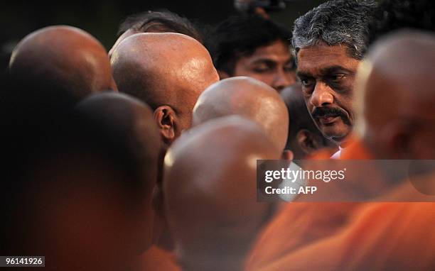 Sri Lanka's opposition presidential candidate Sarath Fonseka looks on during the Buddhist religious act of 'prayer of determination' at the sacred...